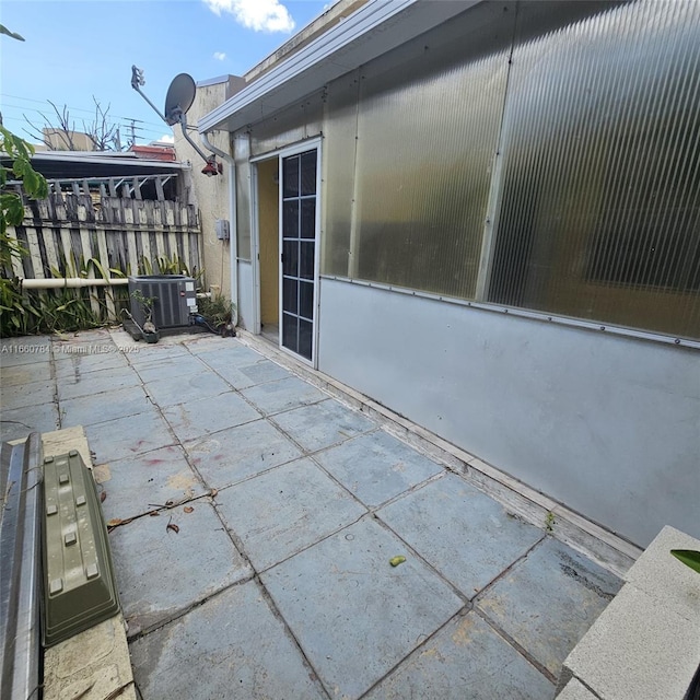 view of patio with fence and central air condition unit