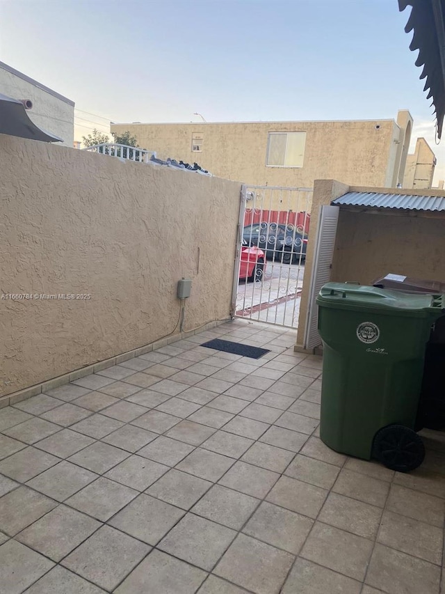 1182 W 37th Ter Unit 11, Hialeah, FL 33012 - view of patio featuring fence and a gate