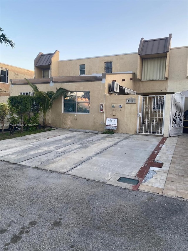1182 W 37th Ter Unit 11, Hialeah, FL 33012 - exterior space featuring a gate and stucco siding