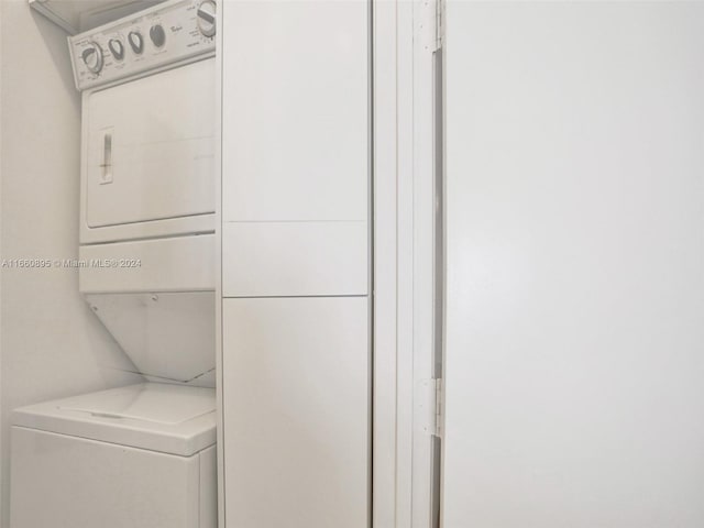 clothes washing area featuring stacked washer / drying machine