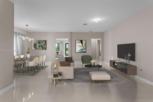 living room with light tile patterned floors and a notable chandelier