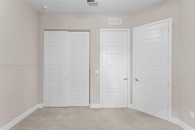 unfurnished bedroom featuring light colored carpet