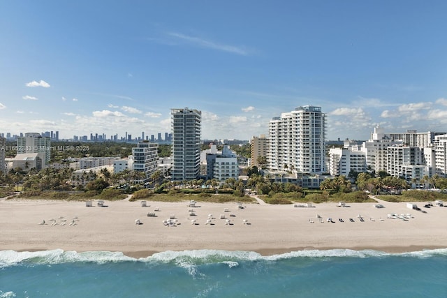 property's view of city with a water view and a beach view