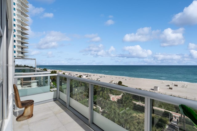 balcony with a water view and a beach view