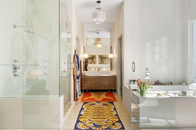 bathroom featuring a stall shower, tile patterned floors, a garden tub, and vanity