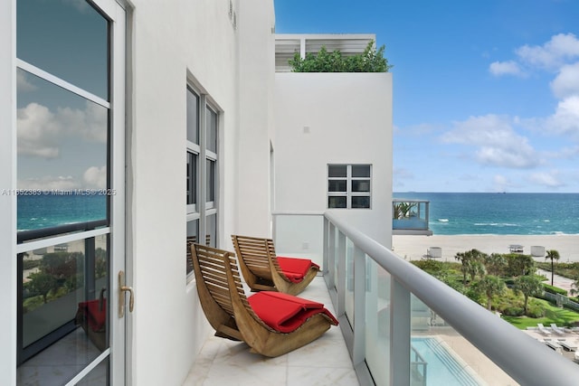 balcony with a beach view and a water view