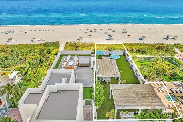 aerial view with a water view and a beach view