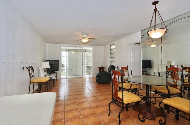 tiled dining space with a wall of windows and ceiling fan