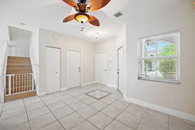 interior space with ceiling fan