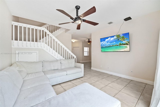 tiled living room with ceiling fan