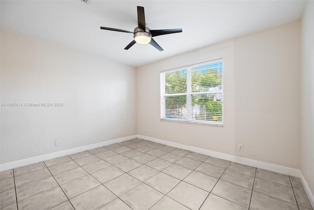 tiled spare room featuring ceiling fan