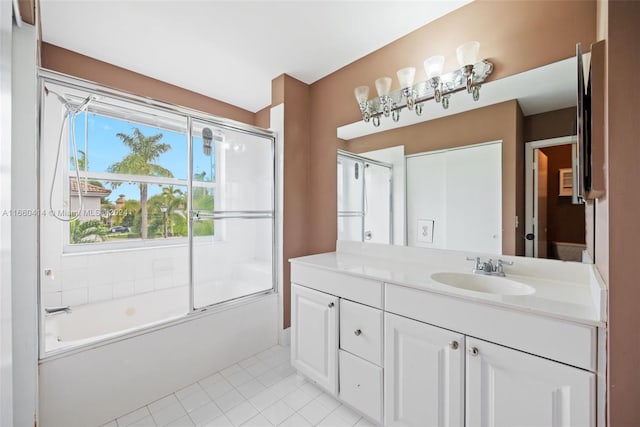 bathroom featuring tile patterned flooring, vanity, and combined bath / shower with glass door