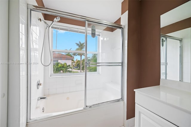 bathroom featuring shower / bath combination with glass door and vanity