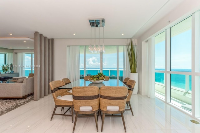 dining room with a water view and a notable chandelier