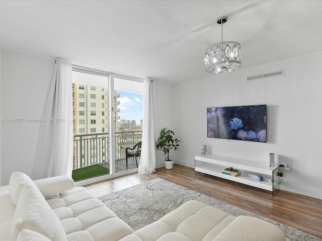 living room with a chandelier and hardwood / wood-style flooring