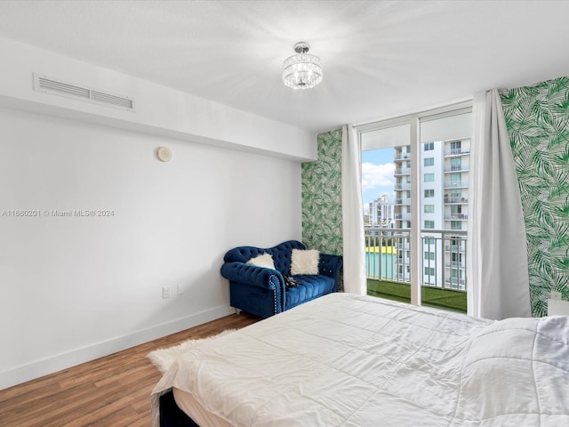 bedroom featuring access to exterior and hardwood / wood-style flooring