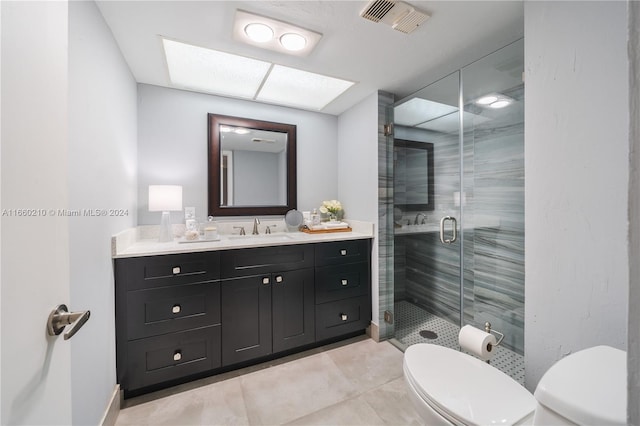 bathroom featuring vanity, tile patterned flooring, toilet, and an enclosed shower