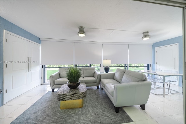 living room with ceiling fan and light tile patterned flooring