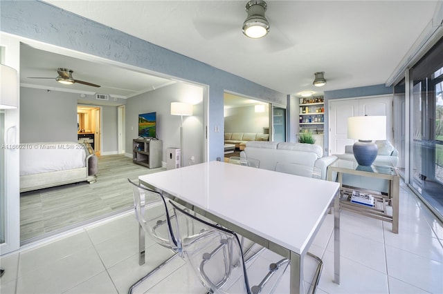 dining area featuring light tile patterned floors and ceiling fan