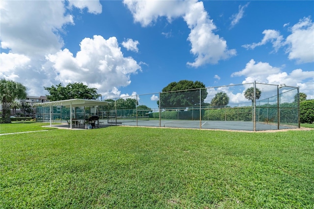 view of sport court with a lawn and tennis court