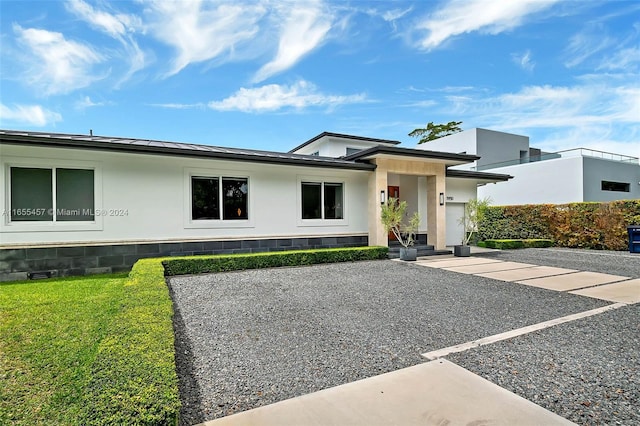 view of front of house featuring a front yard and stucco siding