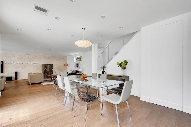 dining area featuring visible vents, baseboards, light wood-type flooring, recessed lighting, and stairway