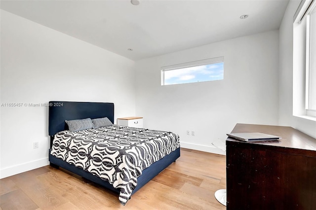 bedroom featuring baseboards and wood finished floors