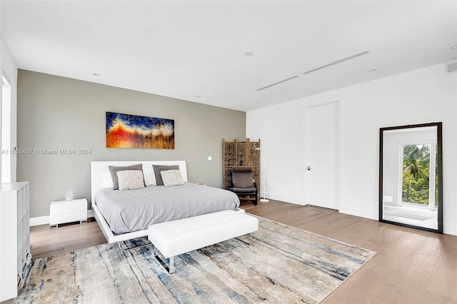 bedroom featuring baseboards and wood finished floors