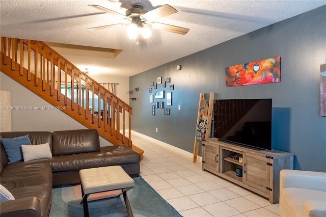 tiled living room with ceiling fan and a textured ceiling