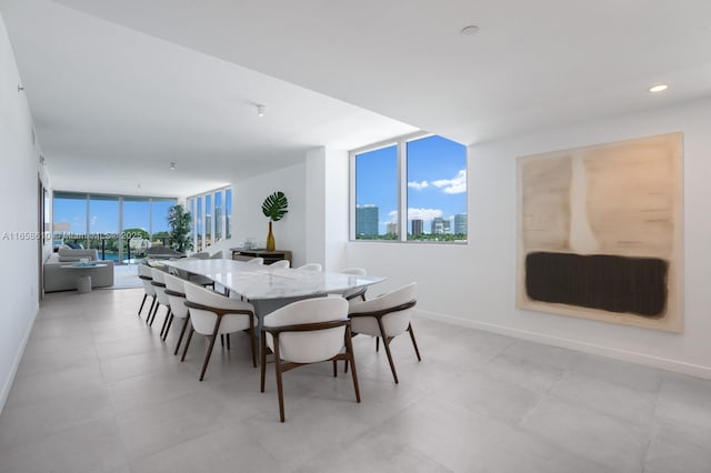 dining space with a wall of windows and a healthy amount of sunlight