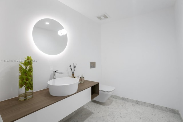 bathroom with vanity and toilet