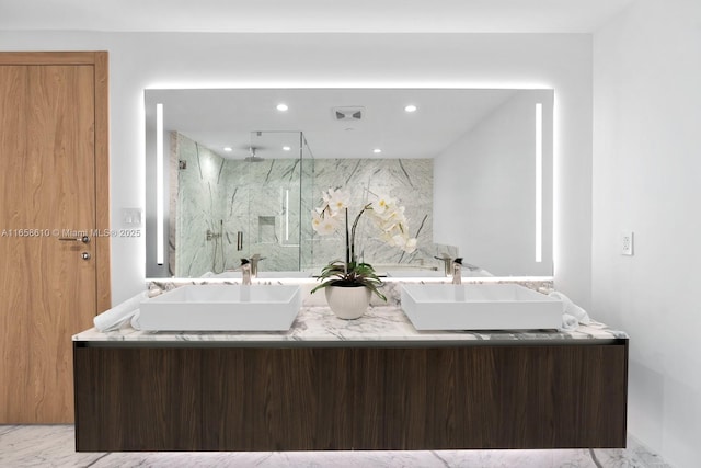 bathroom featuring vanity and a shower with shower door