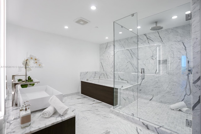 bathroom featuring vanity and separate shower and tub