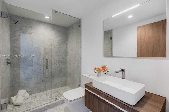 bathroom featuring vanity, an enclosed shower, and toilet