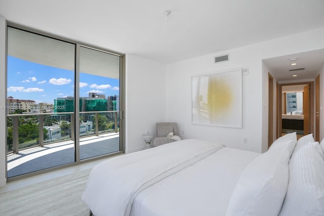 bedroom with access to outside and expansive windows