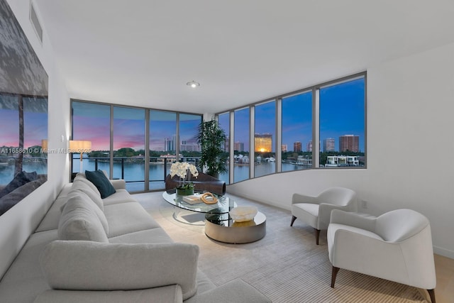 living room with floor to ceiling windows and a water view