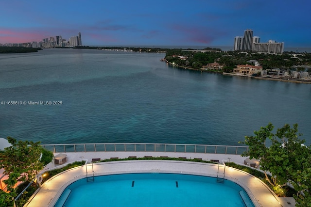 pool at dusk with a water view