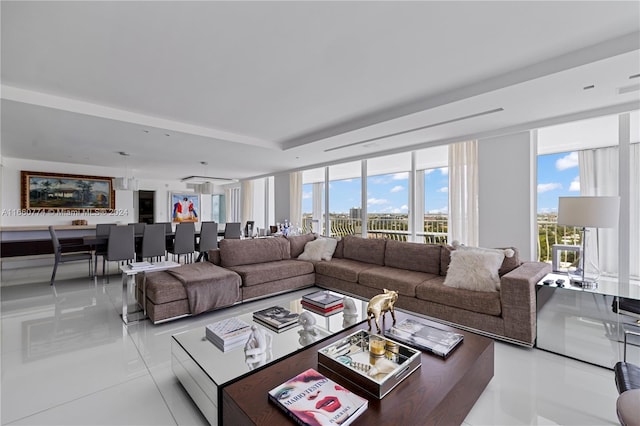 tiled living room featuring floor to ceiling windows and a healthy amount of sunlight