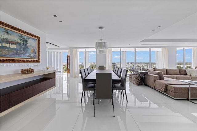 dining room with floor to ceiling windows and light tile patterned floors