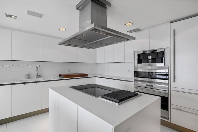 kitchen with white cabinets, island range hood, and a center island