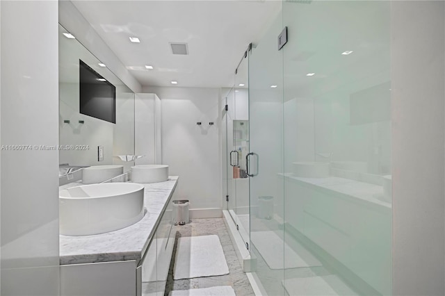 bathroom featuring vanity, tile patterned floors, and a shower with shower door