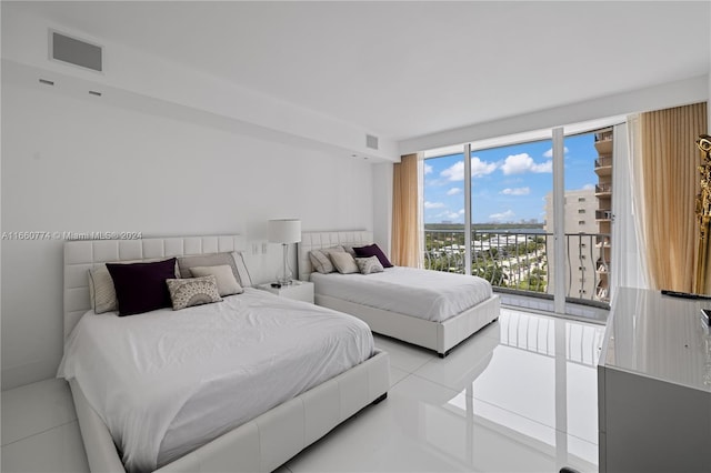 tiled bedroom with floor to ceiling windows