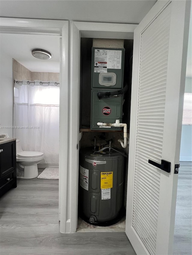 utility room featuring electric water heater