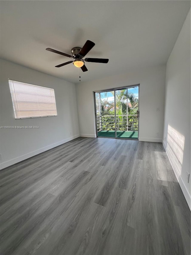 empty room with wood-type flooring and ceiling fan