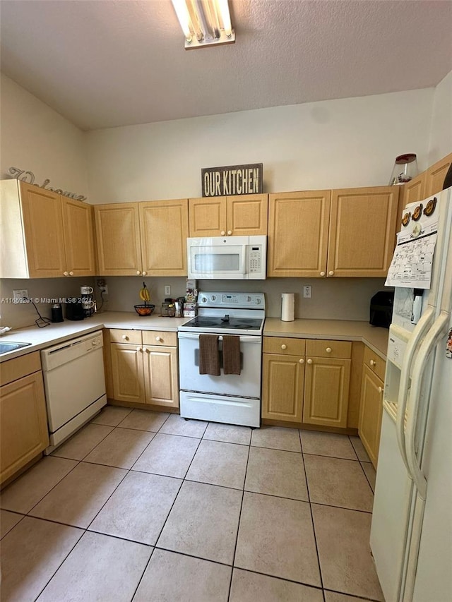 kitchen featuring light brown cabinets, light tile patterned flooring, a textured ceiling, and white appliances