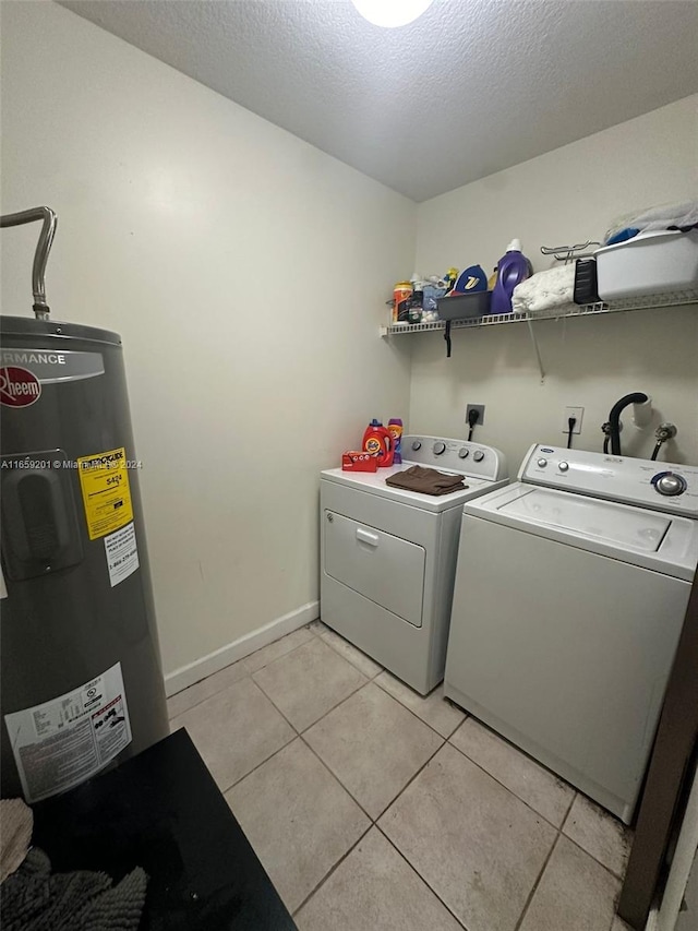 laundry area with light tile patterned floors, water heater, independent washer and dryer, and a textured ceiling