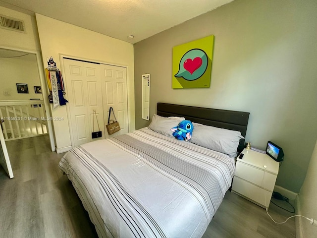 bedroom with hardwood / wood-style flooring and a closet