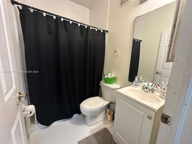 bathroom featuring vanity, tile patterned flooring, toilet, and curtained shower