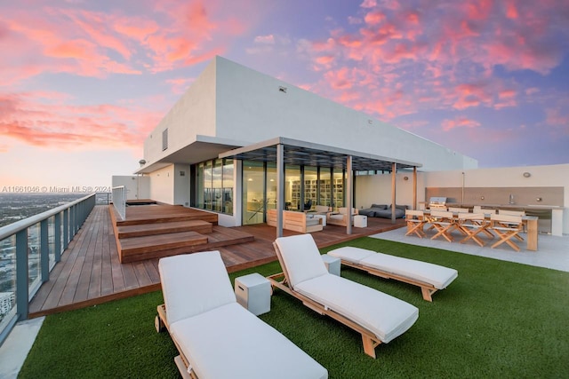 exterior space featuring an outdoor hangout area and a deck