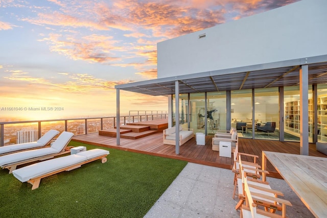 yard at dusk with an outdoor hangout area and a deck